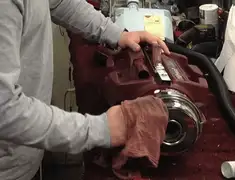 Vacuum repair technician cleaning and servicing a vacuum motor in Bakersfield, CA